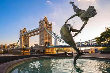 Girl with Dolphin fountain on the north bank of the Thames near Tower Bridge in London, England, UK