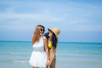 Fototapeta na wymiar Two Asian beautiful girls happy together on the beach,Holiday in summer.