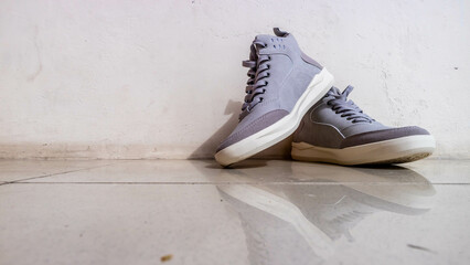 the gray sneakers on the floor