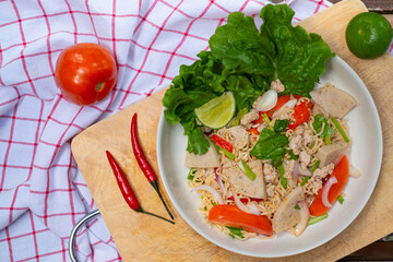 Close up look of Instant noodle spicy salad with spice, Pork, sausage and vegetable ,Spicy Noodle Salad, Mama Noodle Salad, Yum Mama, Thai Street Food. Asian food.