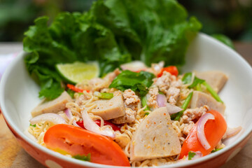 Close up look of Instant noodle spicy salad with spice, Pork, sausage and vegetable ,Spicy Noodle Salad, Mama Noodle Salad, Yum Mama, Thai Street Food. Asian food.