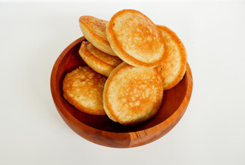Kue Samir or Kamir or Khamir, a traditional pancake from Pemalang, Indonesia, on a wooden bowl isolated with white background