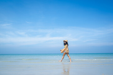 Happy carefree woman enjoying beautiful sea on the beach,Summer holidays concept.