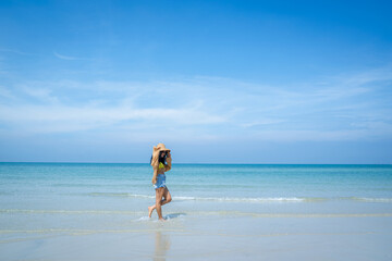 Fototapeta na wymiar Happy carefree woman enjoying beautiful sea on the beach,Summer holidays concept.