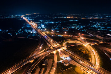 Fototapeta na wymiar Aerial top view of Highway road junctions. Rush hour traffic on multiple highways in city at night. Transportation and cargo delivery in the industrial city.