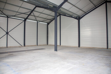 Interior of empty warehouse concrete floor with iron metal structure