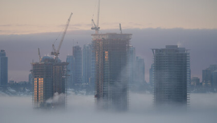 A thick fog blanket covering Metro Vancouver on a winter morning during sunrise in Burnaby, British...