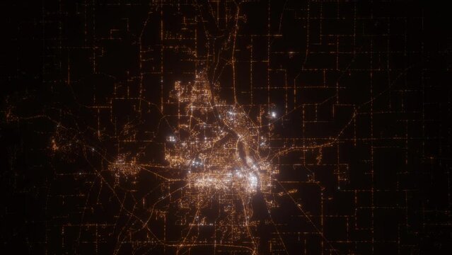 St Cloud (Minnesota, USA) aerial view at night. Top view on modern city with street lights. Camera is flying above the city, moving backward