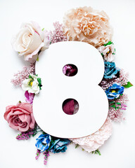 creative floral layout. number eight shape decorated with flowers isolated on white background. top...