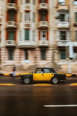 Blurred motion picture of yellow cab on city street