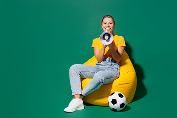 Full body young woman fan wear yellow t-shirt cheer up support football sport team sit in bag chair...
