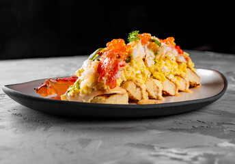 baked brioche, scrambled eggs, and crab meat on plate