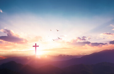 Christian wooden cross on sunset background.