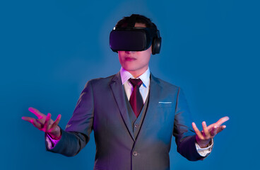 Metaverse concept. Asian businessman wearing vr goggles headset watching touching and communicating...