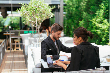 Two business people writing notes