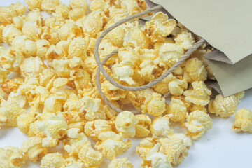 Butter Popcorn scattered on a white background