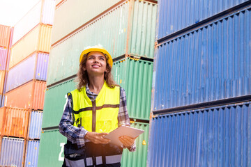 Caucasian female worker using a tablet to check cargo at a container shipping company. The concept of logistics worldwide cargo container