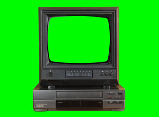 Old black vintage TV with green screen and VCR from 1980s, 1990s, 2000s isolated on green background.