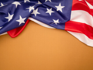 Top view of the American flag on a brown background