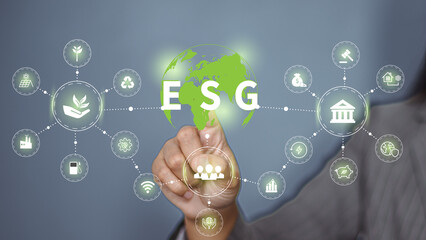 ESG icon concept in the hand for environmental, social, and governance in sustainable and ethical business on the Network connection on a green background.	
