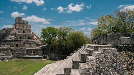 Woman staring at the top of a maya temple, Edzna, Yucatan