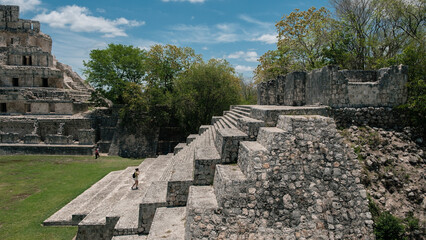 Woman climbing the ruins of the mayas pyramids at Edzna, Yucatan 