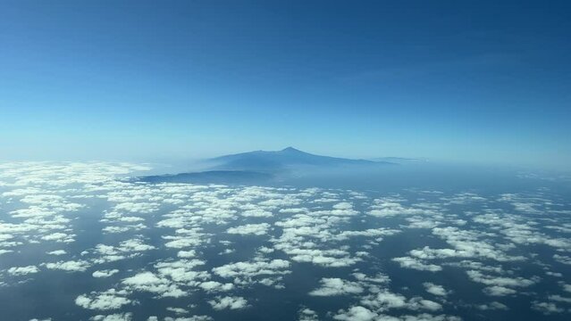 Aerial view from a jet cockpit of Tenerife Island and the Teide volcano during the descent for the approach in a splendid and sunny winter moorning.
