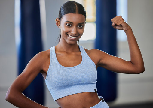 Strong, Fitness And Muscle Of Woman Or Bodybuilder In Portrait With Power, Motivation And Energy In Gym Studio For Training Or Exercise. Body Goals Of An Indian Sports Person Or Athlete With Arm Flex