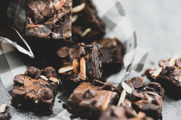 Pieces of fresh brownie face with almonds and chocolate chips