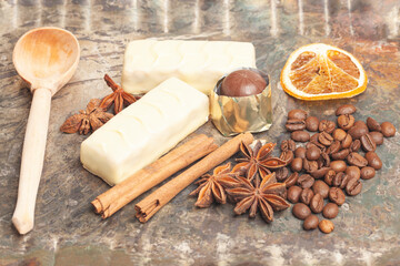 White chocolate candies with anise,cinnamon sticks,coffee beans.