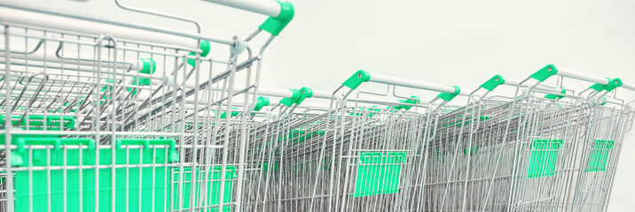 Many same shop trolley. Retail consumer carts. Empty parking store mall. Outside silver basket stock. Metal supermarket wheel.