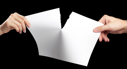 Hands tearing white paper sheet in half, isolated on black background