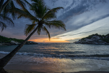 Romantic and scenic sunrise over the ocean at Carbo San Juan in Tayrona national park, Colombia,...
