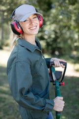 blond woman with hat and machine gardening