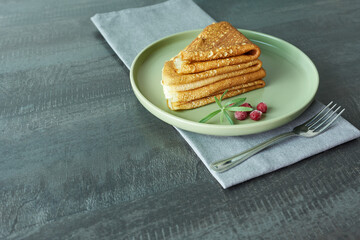 Pancakes with a sprig of lingonberries on a plate. Breakfast.