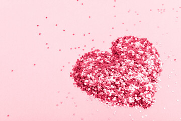A heart made of small sequins. Color 2023, viva magenta. Space for copying. Flat position, top view