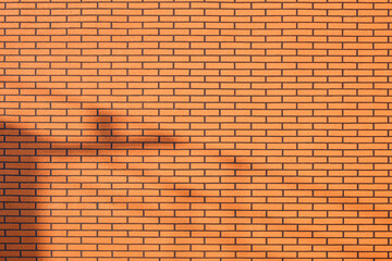 Artificial brick pattern background of insulation panel on decorative vintage building wall with sunlight and shadow on surface