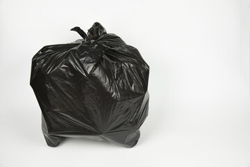 plastic bottles in black garbage bag isolated on white background .plastic bottles in black garbage...