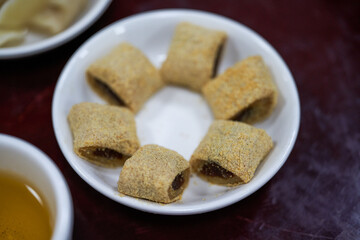 A plate of old Beijing traditional dessert snacks, donkey rolling