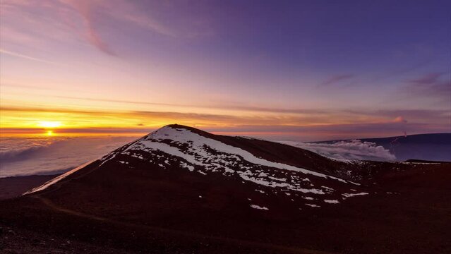 Stunning views of the sunrise and Mauna Loa erupting from the top of Mauna Kea's observatory.
