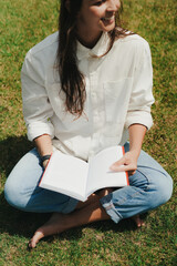 Girl Reading and Walking on Grass, Phone
