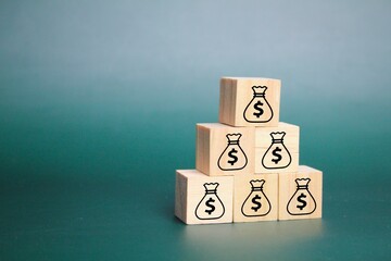 wooden cube with money icon hierarchical arrangement. money management concept. passive income. money saving concept.