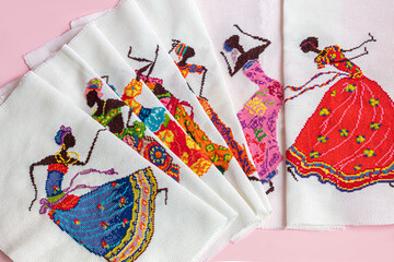 Obraz premium Handmade embroidery. Multicolored patterns on white fabric. Ethnic drawing.