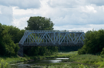 View of the steel railway bridge over a small river