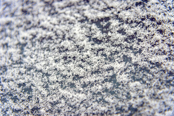 Winter snow background.Frosted background.Abstract frosty pattern on glass.Frosty patterns on the glass with empty space for text.