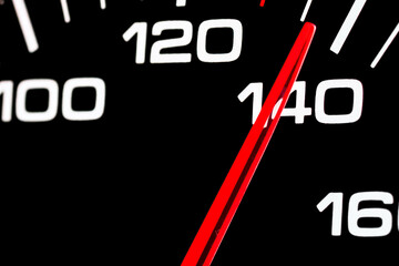 Car speedometer. Auto car speedometer shows 140 speed.Closeup shot,dark black background.Automobile...