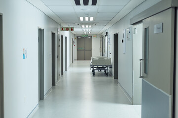Moveable hospital bed in an empty hospital corridor, copy space