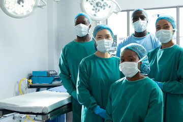 Portrait of diverse group of surgeons ready for surgery in operating theatre, with copy space