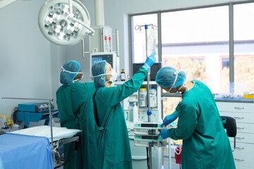 Diverse female surgical techs checking and setting up equipment in operating theatre