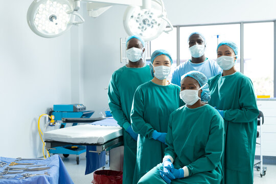 Portrait Of Diverse Group Of Smiling Surgeons In Masks In Operating Theatre, Copy Space